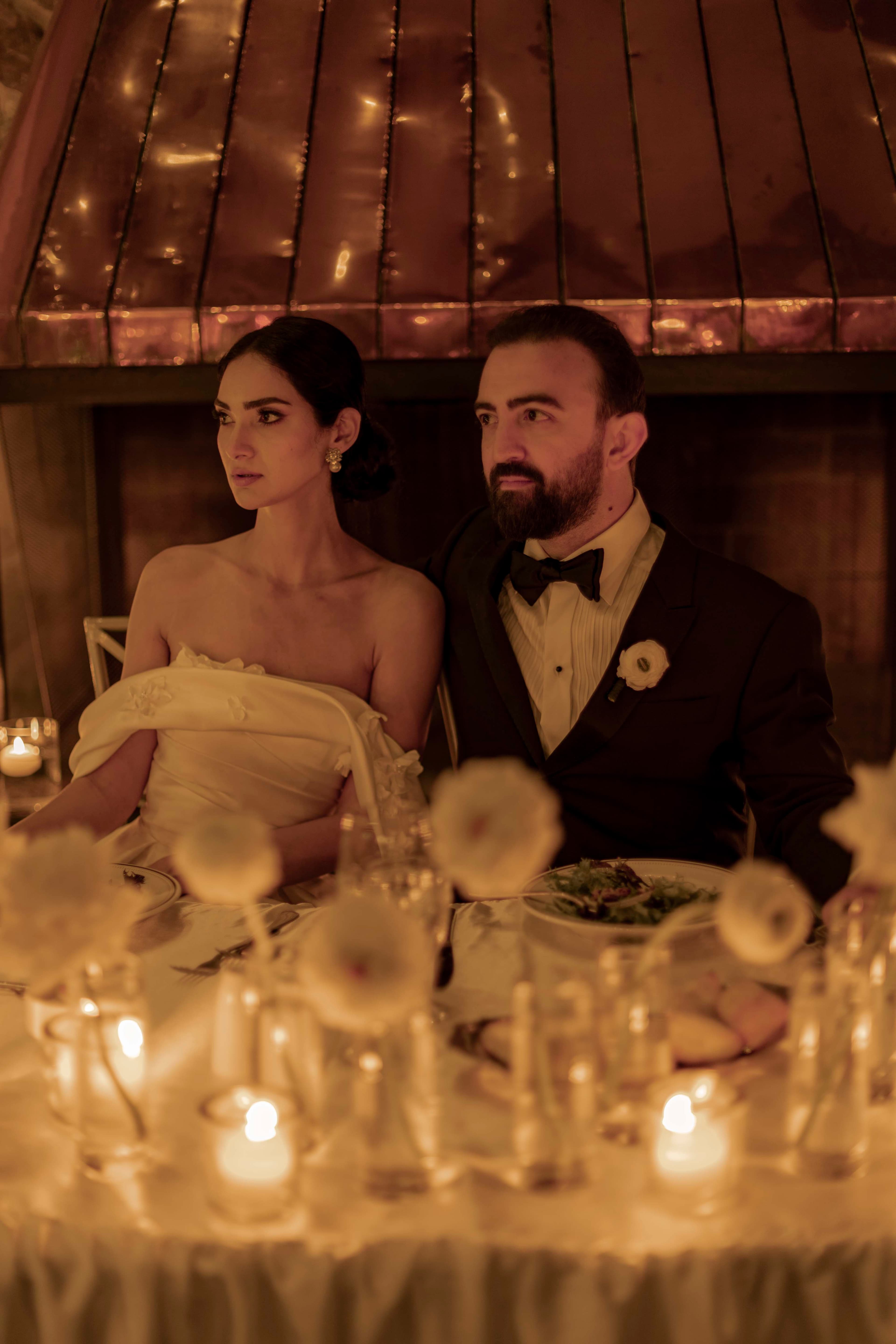 Seated together at a candlelit table