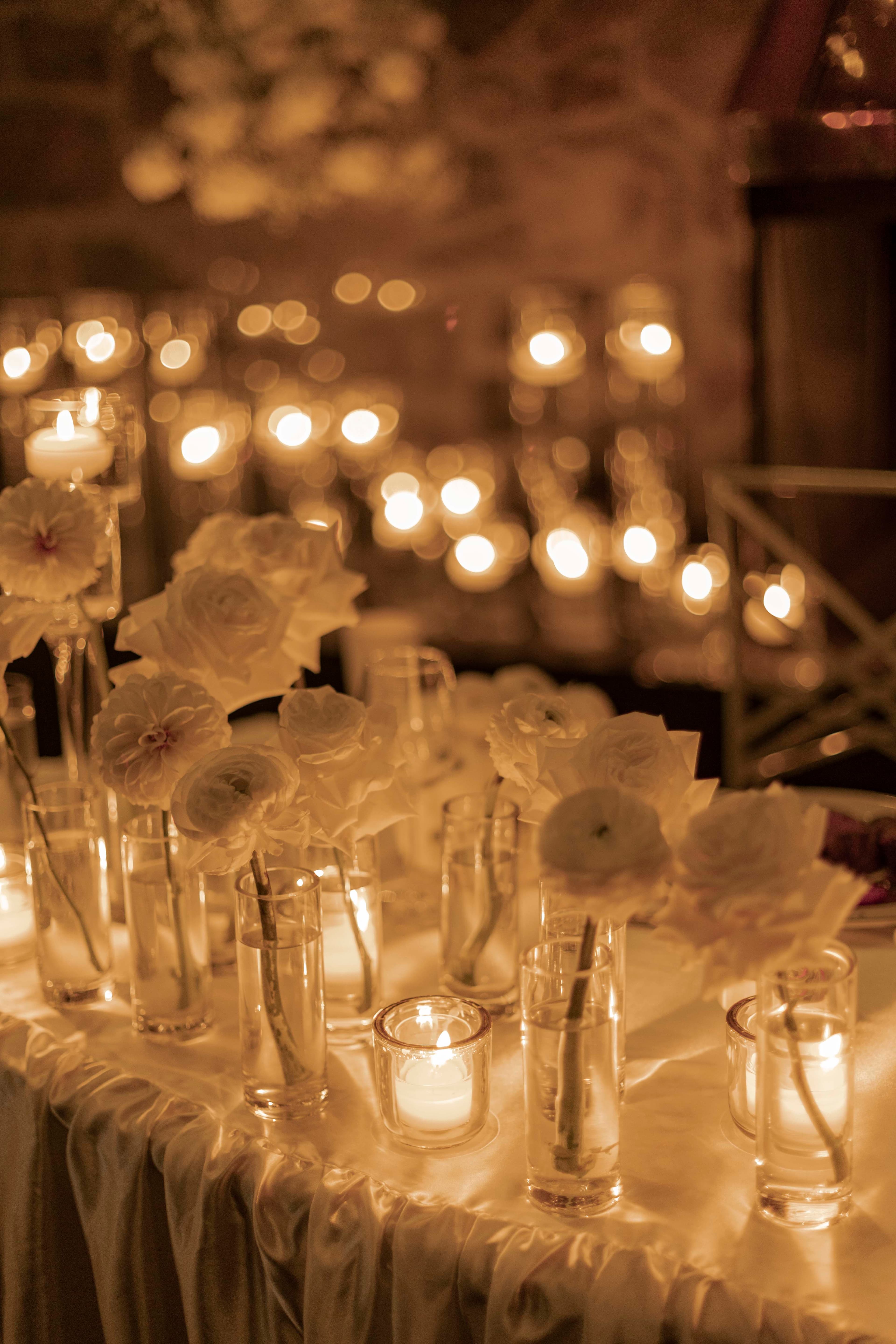 Candlelight and flowers running the length of a table